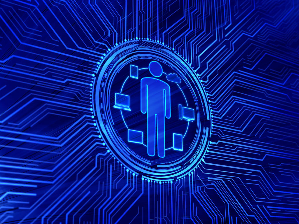 Human at the center of technology including laptops, phones, and computers